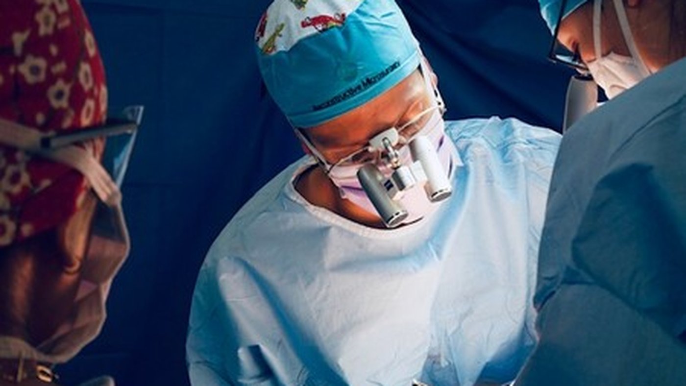 Surgeon in the operating room wearing magnifying loupes